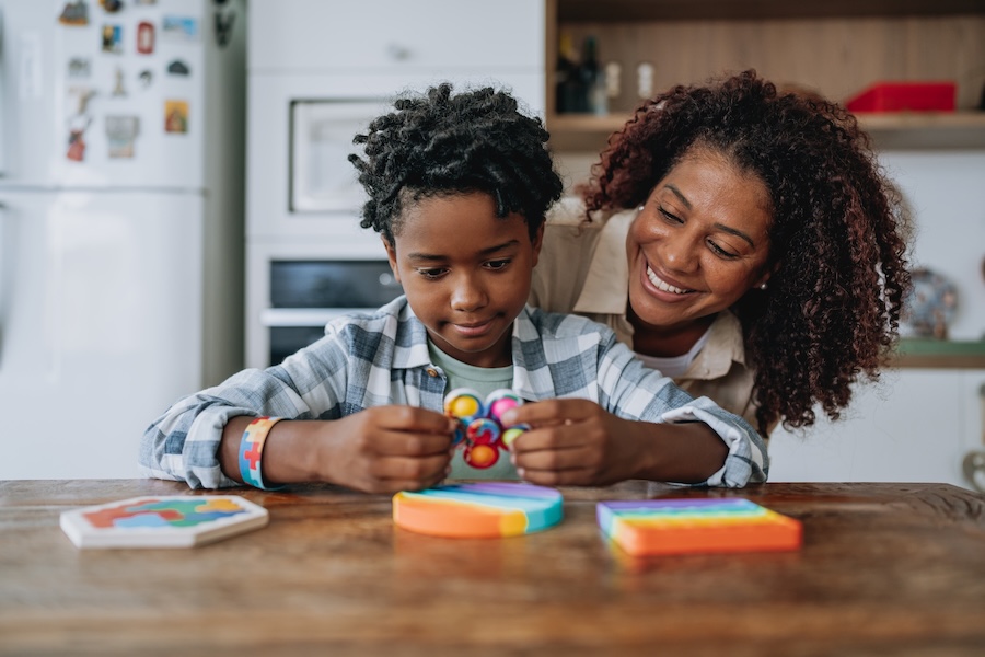 mother playing with son with autism, dental health for autism, oral health autism