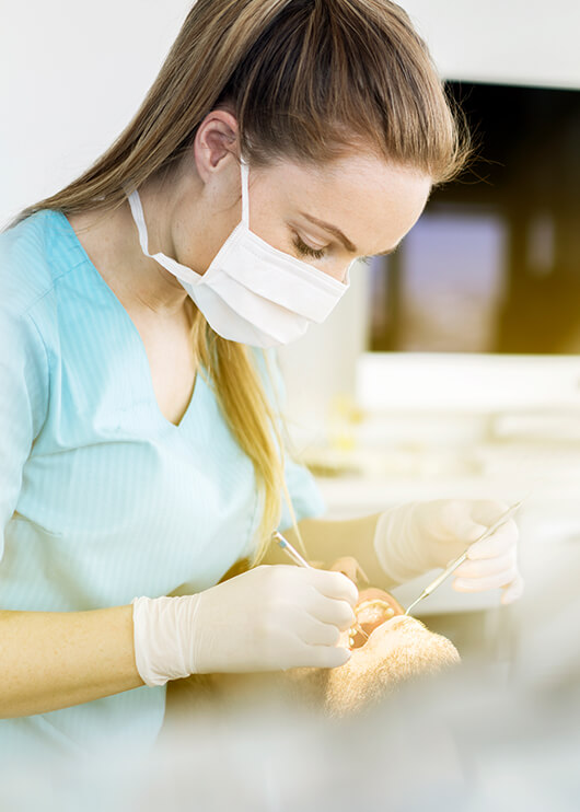 dental hygienist working with a patient