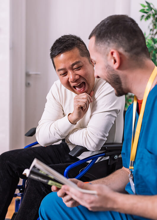 dental assistant talking with a wheelchair-bound man