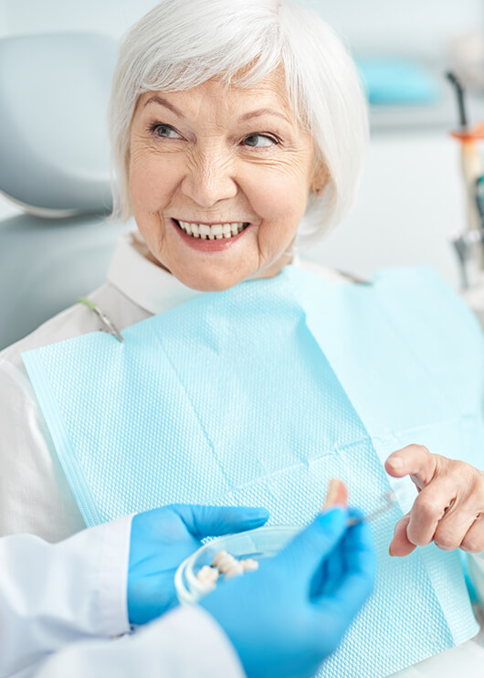 senior woman talking with her dentist