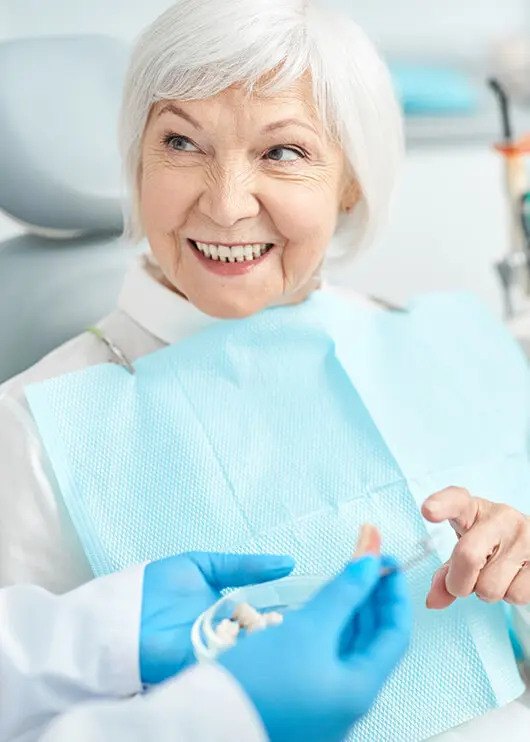 senior woman talking with her dentist