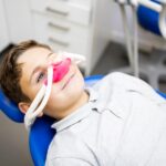 young boy using dental sedation, which can help patients with autism or sensory processing disorder
