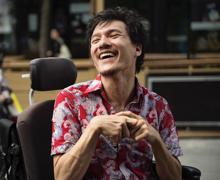 man with cerebral palsy, which can make oral hygiene challenging, disabilities