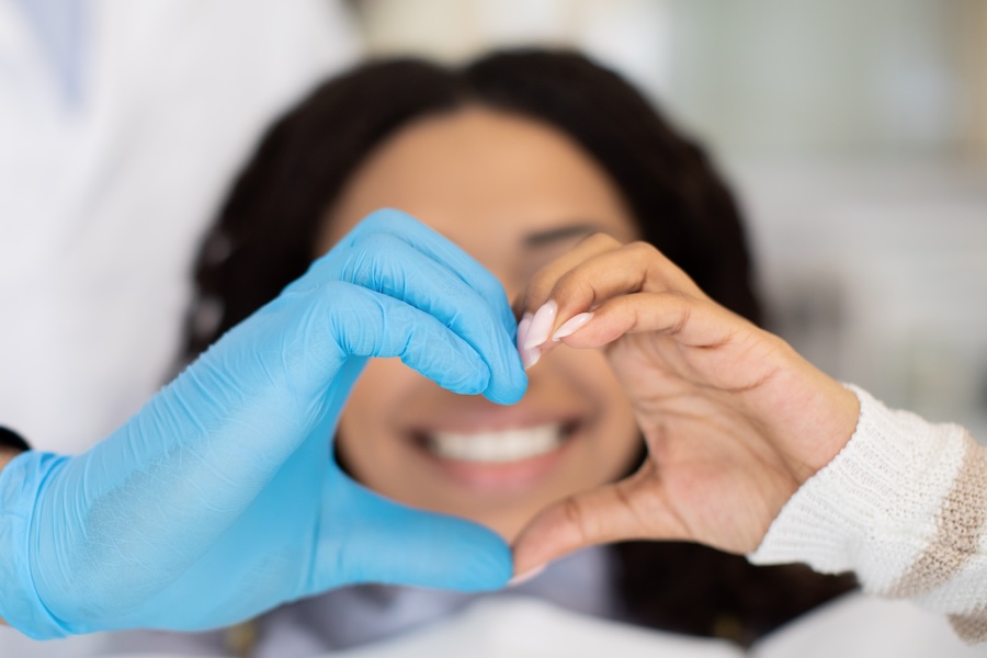 dentist and patient making a heart with their hands, blood thinner, high risk dentistry